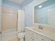 Cozy bathroom with a tub, shower combination, and a stylish single sink vanity at 13135 Plantation Ter, Seminole, FL 33776