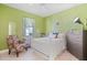 Charming bedroom with bright green walls and a comfortable chair at 13135 Plantation Ter, Seminole, FL 33776
