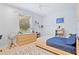 Serene bedroom featuring light wood floors and a window with natural light at 13135 Plantation Ter, Seminole, FL 33776