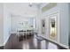 Bright dining room features hardwood floors, chandelier, and decorative front doors at 13135 Plantation Ter, Seminole, FL 33776