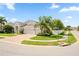 Charming single-Gathering home with a three-car garage, lush landscaping, and a circular brick driveway at 13135 Plantation Ter, Seminole, FL 33776
