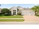 Charming single-story home featuring a three-car garage, well-manicured lawn, and beautiful landscaping at 13135 Plantation Ter, Seminole, FL 33776