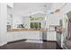 Bright kitchen with granite countertops, stainless steel appliances, and a view of the backyard at 13135 Plantation Ter, Seminole, FL 33776