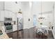 Well-lit kitchen with stainless steel appliances, white cabinets, and a dining area at 13135 Plantation Ter, Seminole, FL 33776