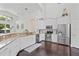 Modern kitchen with stainless steel appliances, granite countertops, and stylish white cabinetry at 13135 Plantation Ter, Seminole, FL 33776