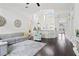 Open-concept living area with high ceilings, dark hardwood floors, and seamless flow to the kitchen at 13135 Plantation Ter, Seminole, FL 33776