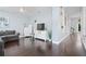 Open-concept living room features hardwood floors, white trim, and bright light at 13135 Plantation Ter, Seminole, FL 33776