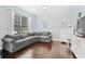 Cozy living room featuring hardwood floors, large window, and comfortable couch at 13135 Plantation Ter, Seminole, FL 33776