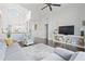 Bright living room with dark hardwood floors, a modern grey sofa, and a decorative area rug at 13135 Plantation Ter, Seminole, FL 33776
