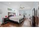 Spacious main bedroom with hardwood floors, fan, and lots of natural light at 13135 Plantation Ter, Seminole, FL 33776