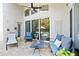 Covered patio with comfortable seating provides a cozy outdoor living space at 13135 Plantation Ter, Seminole, FL 33776