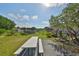 Exterior view of backyard with white picnic table and lawn mower at 13208 Sydney Rd, Dover, FL 33527