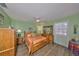 Bedroom featuring light walls, wood floors, and ceiling fan at 13208 Sydney Rd, Dover, FL 33527