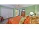 Bright bedroom with ceiling fan, closet and view to the bathroom at 13208 Sydney Rd, Dover, FL 33527