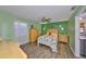 Bright bedroom with green walls, light wood furniture, and a ceiling fan at 13208 Sydney Rd, Dover, FL 33527