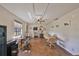 Large bonus room with tables, workspace, a ceiling fan, and ample lighting at 13208 Sydney Rd, Dover, FL 33527