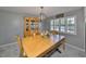 Charming dining room features natural lighting, a wooden table, and a vintage china cabinet at 13208 Sydney Rd, Dover, FL 33527