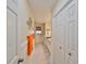 Hallway view with marble floors, wainscoting, closet, and bathroom at 13208 Sydney Rd, Dover, FL 33527