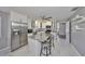Bright kitchen with white cabinets, stainless steel appliances, and a center island with seating at 13208 Sydney Rd, Dover, FL 33527