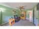 Cozy living room with a ceiling fan, recliner, and view into the adjacent bathroom at 13208 Sydney Rd, Dover, FL 33527