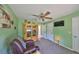 Bright living room features a ceiling fan, cabinet, and convenient bathroom access at 13208 Sydney Rd, Dover, FL 33527