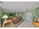 Inviting living room with a ceiling fan, wood shutters, and tiled entrance at 13208 Sydney Rd, Dover, FL 33527