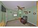 Well-lit living room with a ceiling fan, comfortable recliner, and stylish decor at 13208 Sydney Rd, Dover, FL 33527