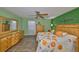 Comfortable main bedroom features a ceiling fan, hardwood floors, and decorative accents at 13208 Sydney Rd, Dover, FL 33527