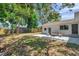 Inviting backyard featuring stone patio with seating, new lawn, and lush landscaping at 1401 49Th N St, St Petersburg, FL 33710