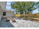 Spacious backyard featuring a stone patio with wooden furniture, and well-maintained lawn at 1401 49Th N St, St Petersburg, FL 33710