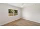 Sunlit bedroom with light wood floors, clean white walls, and a view of the fenced backyard at 1401 49Th N St, St Petersburg, FL 33710