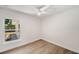 Bright bedroom with light wood floors and a window with a view of the backyard patio at 1401 49Th N St, St Petersburg, FL 33710