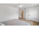 Minimalist bedroom with light hardwood flooring, white walls, and ensuite bathroom with glass-doored shower at 1401 49Th N St, St Petersburg, FL 33710