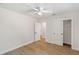 Minimalist bedroom features light hardwood floors, white walls, and a white closet with sliding doors at 1401 49Th N St, St Petersburg, FL 33710