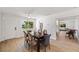 Bright dining room features hardwood floors, a modern ceiling fan, and ample natural light from large windows at 1401 49Th N St, St Petersburg, FL 33710