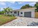 Attractive home showcasing a well-maintained driveway, attached garage, and manicured landscaping at 1401 49Th N St, St Petersburg, FL 33710