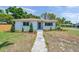 Well-maintained home featuring a concrete walkway leading to the entrance and a beautifully landscaped front yard at 1401 49Th N St, St Petersburg, FL 33710