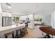 Modern kitchen featuring white cabinets, stainless steel appliances, a center island with seating, and hardwood floors at 1401 49Th N St, St Petersburg, FL 33710