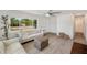 Bright living room featuring hardwood floors, a large window, and stylish furnishings, creating an inviting atmosphere at 1401 49Th N St, St Petersburg, FL 33710