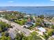 Aerial view of the house and neighborhood with river front access, highlighting the pool, landscaping, and surrounding area at 1542 Bayshore Blvd, Dunedin, FL 34698