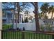 Backyard view from a balcony showcasing a white fenced lawn at 1542 Bayshore Blvd, Dunedin, FL 34698