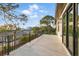 Large balcony with black railing, overlooking lush greenery and neighborhood at 1542 Bayshore Blvd, Dunedin, FL 34698