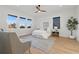 Relaxing bedroom features hardwood floors, a ceiling fan, and large windows with picturesque views at 1542 Bayshore Blvd, Dunedin, FL 34698