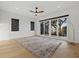 Modern bedroom featuring a ceiling fan, a sliding glass door, and an expansive view, creating a serene retreat at 1542 Bayshore Blvd, Dunedin, FL 34698