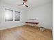 Bright room showcasing beautiful hardwood floors, modern window shades, and a unique massage table at 1542 Bayshore Blvd, Dunedin, FL 34698