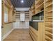 Spacious walk-in closet with custom shelving, drawer units and unique decorative ceiling at 1542 Bayshore Blvd, Dunedin, FL 34698