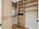 Walk-in closet features built-in shelving and drawers for optimal organization and storage space at 1542 Bayshore Blvd, Dunedin, FL 34698
