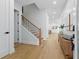 Light and bright hallway with wood staircase and view to the dining area at 1542 Bayshore Blvd, Dunedin, FL 34698