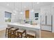 Bright kitchen featuring a spacious island with seating, modern appliances, and stylish pendant lighting at 1542 Bayshore Blvd, Dunedin, FL 34698