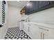 Well-appointed laundry room with custom cabinetry, modern appliances, and a stylish patterned floor at 1542 Bayshore Blvd, Dunedin, FL 34698